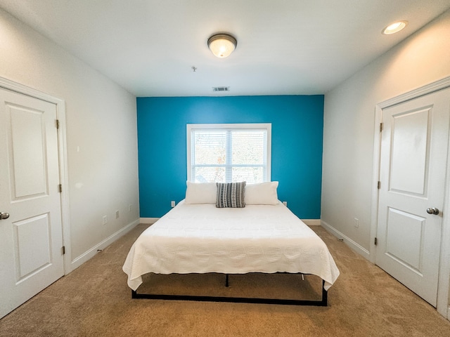 bedroom with light colored carpet