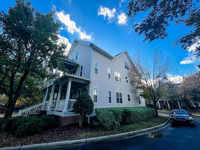 view of side of property featuring a porch