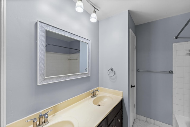 full bathroom with washtub / shower combination, double vanity, and a sink