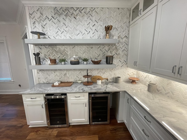 kitchen with white cabinetry, hanging light fixtures, kitchen peninsula, appliances with stainless steel finishes, and custom exhaust hood