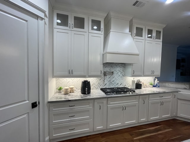 interior space featuring white cabinetry, light stone countertops, and dark hardwood / wood-style floors