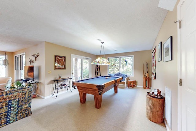 playroom with a wealth of natural light, light colored carpet, a textured ceiling, and billiards