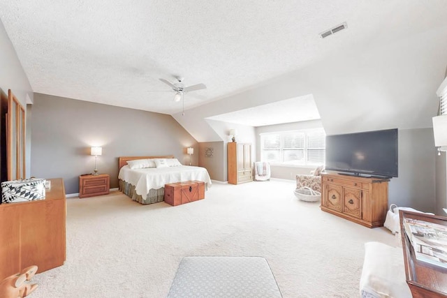 bedroom featuring ceiling fan, lofted ceiling, light carpet, and a textured ceiling