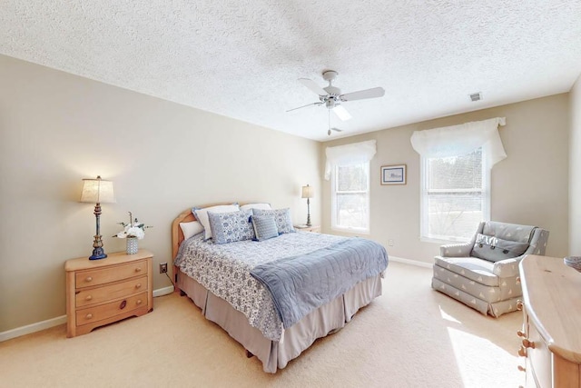 carpeted bedroom with a textured ceiling and ceiling fan