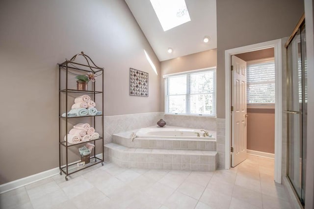 bathroom with high vaulted ceiling, a skylight, tile patterned flooring, and independent shower and bath