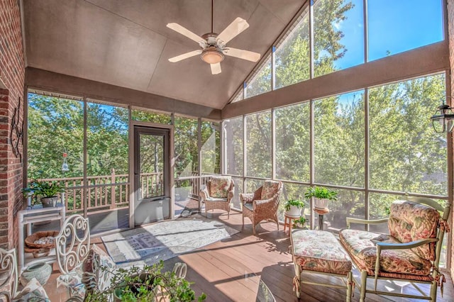 sunroom / solarium with lofted ceiling and ceiling fan