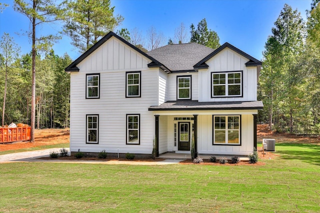 modern farmhouse featuring a porch, a front yard, and central air condition unit