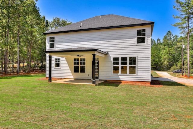 rear view of property with a patio area and a lawn