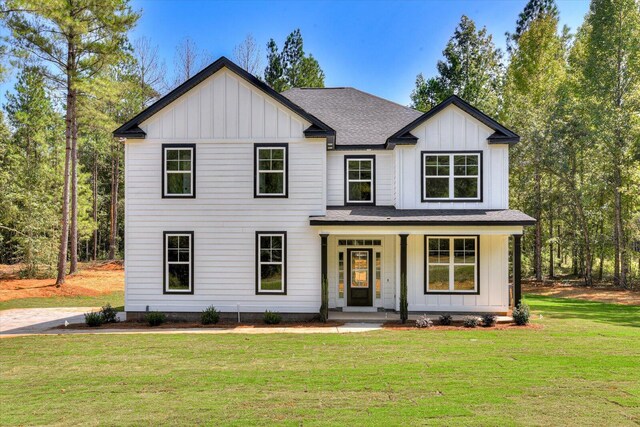 view of front of house with covered porch and a front lawn