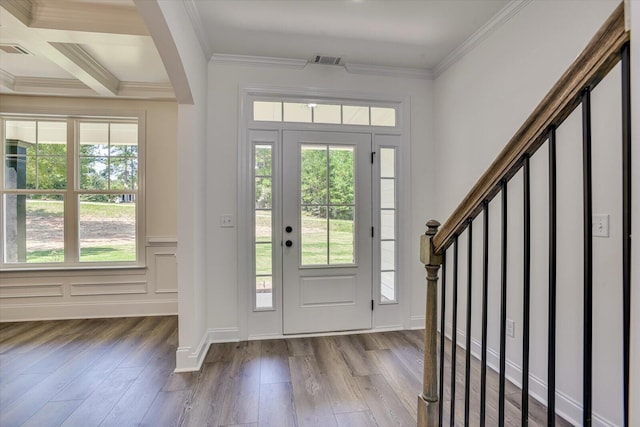 entrance foyer featuring ornamental molding and light wood-type flooring