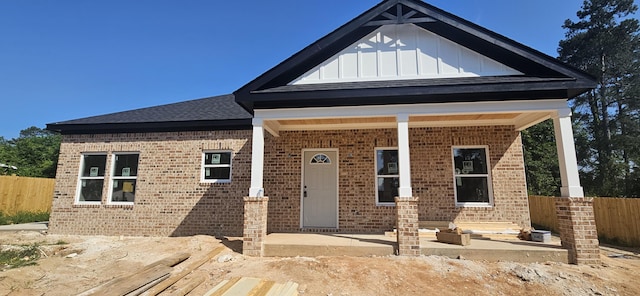 331 2nd Ave, North Augusta, SC 29841 - view of front facade with brick siding, board and batten siding, a patio, and a shingled roof