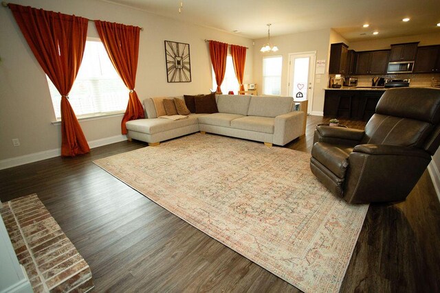 1144 George W Crawford Dr, Augusta, GA 30909 - living room featuring a chandelier, baseboards, healthy amount of natural light, dark wood-style flooring, and recessed lighting