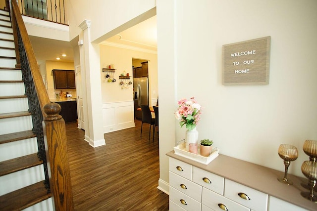 1144 George W Crawford Dr, Augusta, GA 30909 - foyer featuring dark wood-type flooring, ornamental molding, stairway, a wainscoted wall, and baseboards
