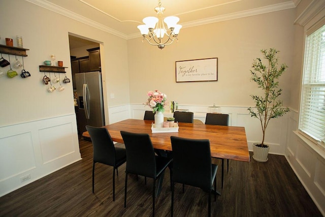 1144 George W Crawford Dr, Augusta, GA 30909 - dining room featuring dark wood-type flooring, a chandelier, a decorative wall, crown molding, and wainscoting