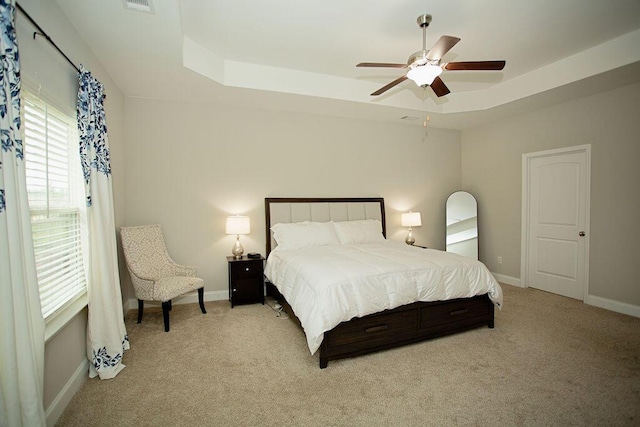 1144 George W Crawford Dr, Augusta, GA 30909 - bedroom with a raised ceiling, light carpet, and baseboards