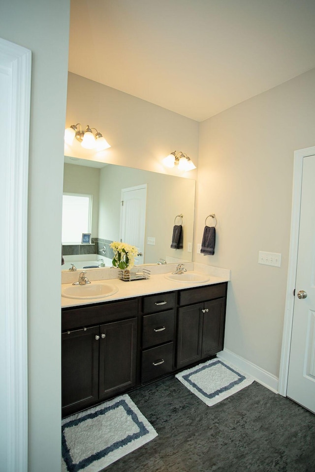 1144 George W Crawford Dr, Augusta, GA 30909 - bathroom with double vanity, a bathtub, and baseboards