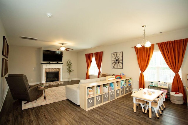 1144 George W Crawford Dr, Augusta, GA 30909 - living room featuring ceiling fan, dark wood-style flooring, a brick fireplace, and baseboards