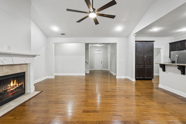 4752 Storey Mill Rd, Hephzibah, GA 30815 - unfurnished living room with ceiling fan, lofted ceiling, a tiled fireplace, and dark wood-style floors