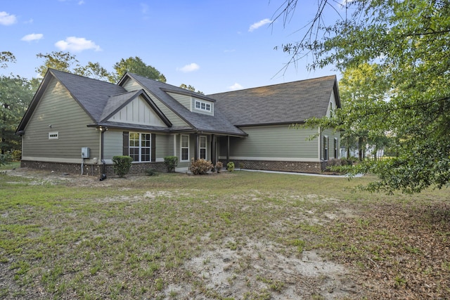 4752 Storey Mill Rd, Hephzibah, GA 30815 - view of front of house featuring a shingled roof, a front lawn, board and batten siding, and brick siding