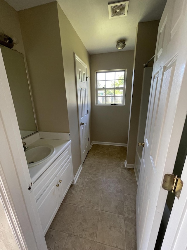 1420 Perry Ave, Augusta, GA 30901 - bathroom featuring vanity, baseboards, and tile patterned floors