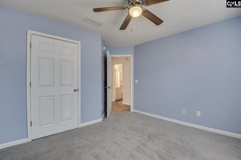 unfurnished bedroom with ceiling fan and light carpet