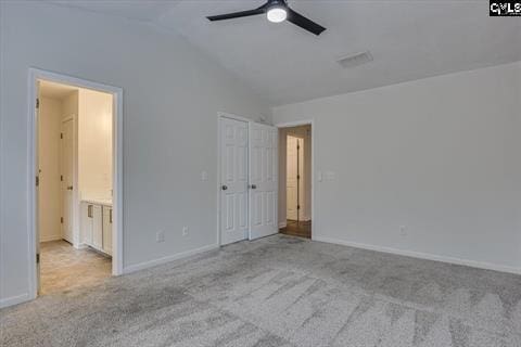 unfurnished bedroom featuring light carpet, ceiling fan, and lofted ceiling