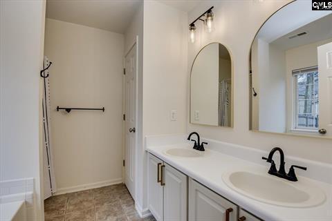 bathroom featuring vanity and a bathtub