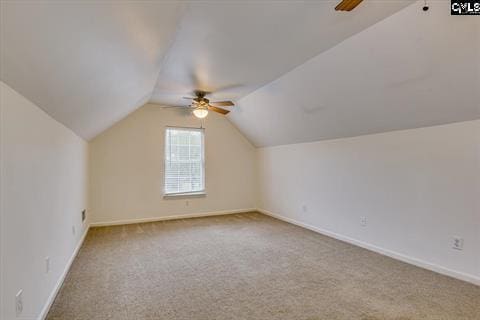 additional living space featuring carpet floors, ceiling fan, and lofted ceiling