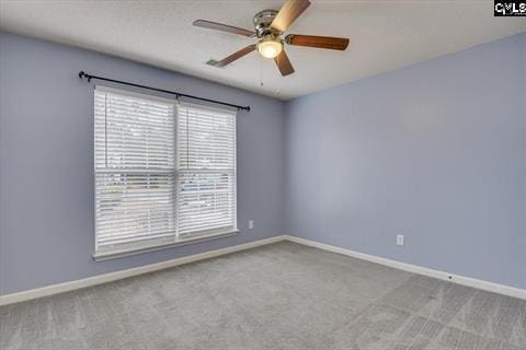 empty room featuring ceiling fan and light colored carpet