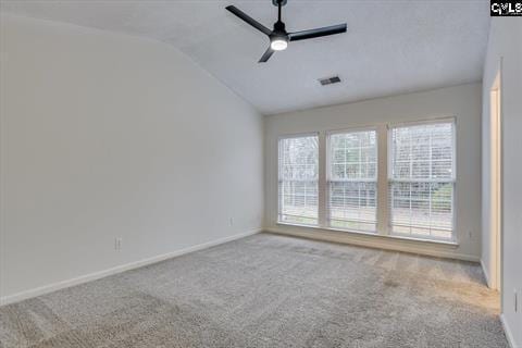 carpeted empty room with ceiling fan and vaulted ceiling