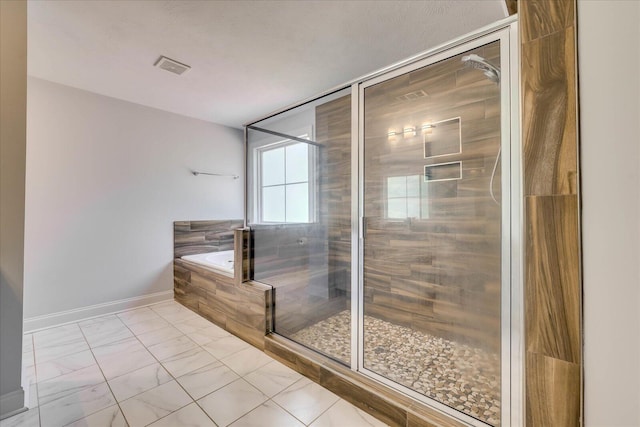 7054 Rance Perry Rd, Appling, GA 30802 - full bathroom with a shower stall, a bath, baseboards, and visible vents