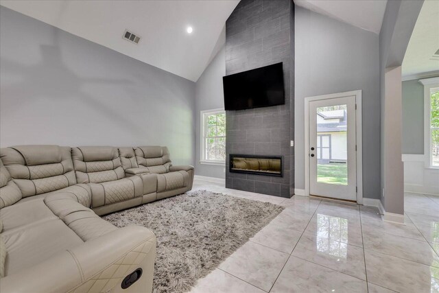 7054 Rance Perry Rd, Appling, GA 30802 - living room featuring baseboards, high vaulted ceiling, a tiled fireplace, and visible vents