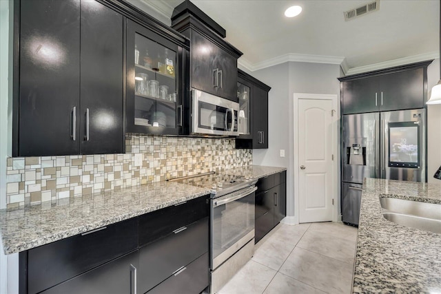 7054 Rance Perry Rd, Appling, GA 30802 - kitchen with dark cabinets, tasteful backsplash, crown molding, visible vents, and stainless steel appliances