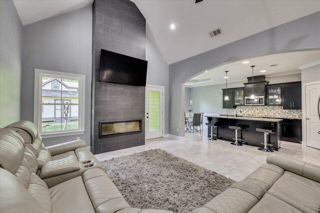 7054 Rance Perry Rd, Appling, GA 30802 - living room with visible vents, high vaulted ceiling, arched walkways, and a fireplace
