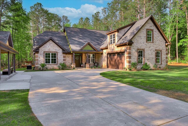 7054 Rance Perry Rd, Appling, GA 30802 - view of front of property featuring concrete driveway, a front yard, a garage, and brick siding