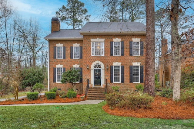 colonial-style house with a front yard