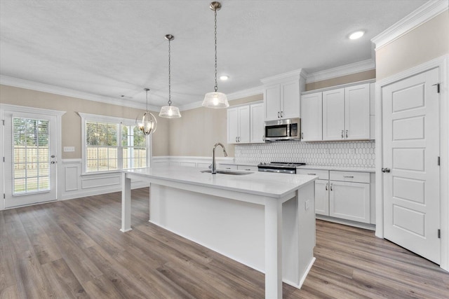 5921 Big Pond Trl, Grovetown, GA 30813 - kitchen with appliances with stainless steel finishes, light countertops, a kitchen island with sink, a chandelier, and white cabinetry