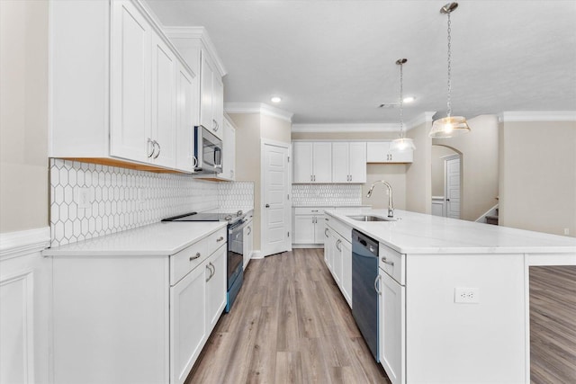5921 Big Pond Trl, Grovetown, GA 30813 - kitchen featuring appliances with stainless steel finishes, white cabinetry, light countertops, decorative backsplash, and ornamental molding