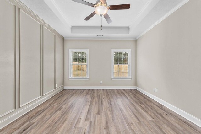 5921 Big Pond Trl, Grovetown, GA 30813 - unfurnished room with a tray ceiling, light wood-type flooring, ornamental molding, and a ceiling fan