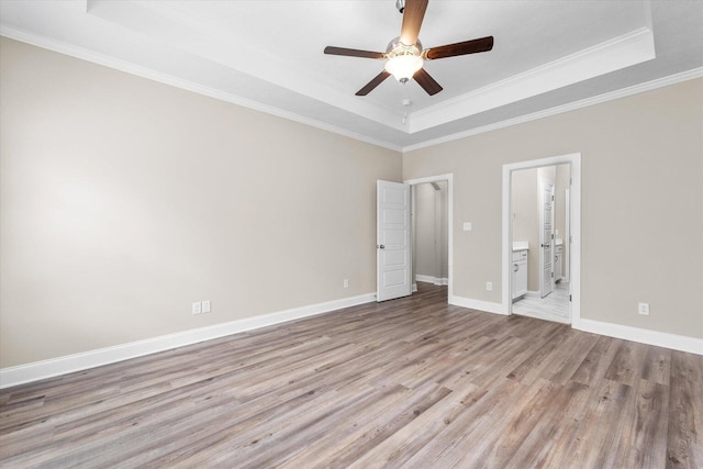 5921 Big Pond Trl, Grovetown, GA 30813 - unfurnished bedroom featuring a raised ceiling, light wood-type flooring, ornamental molding, connected bathroom, and a ceiling fan