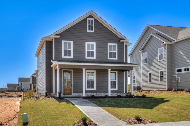 view of front of home featuring a front lawn, central AC unit, and covered porch