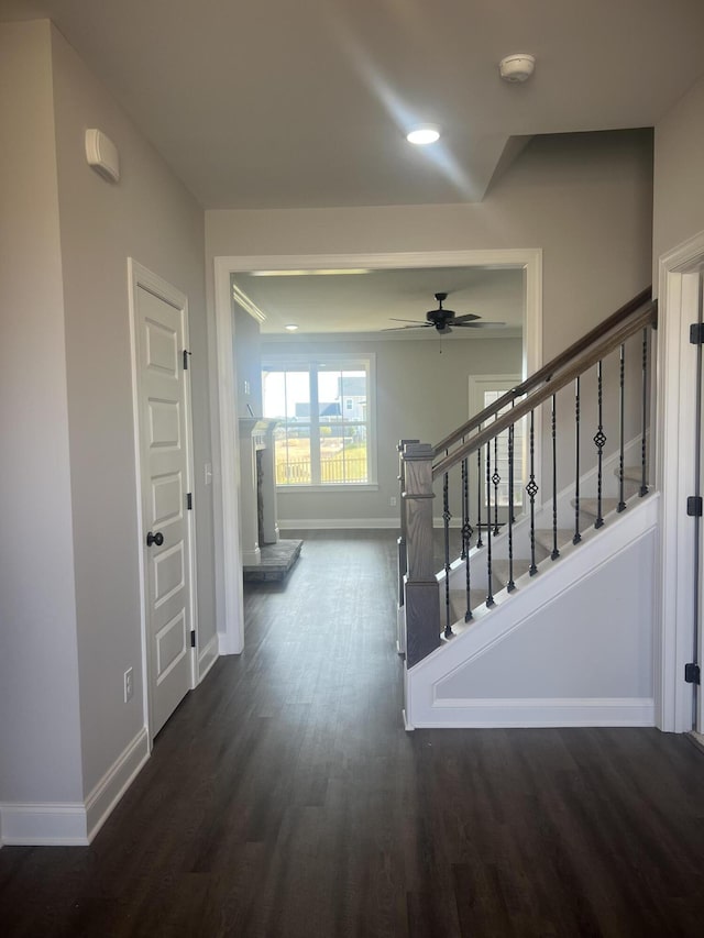 corridor featuring stairs, baseboards, dark wood-type flooring, and recessed lighting