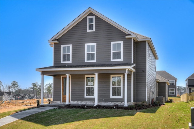 view of front of house featuring a porch, central AC, and a front yard