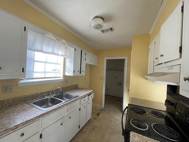 kitchen featuring visible vents, range with electric stovetop, a sink, and white cabinetry