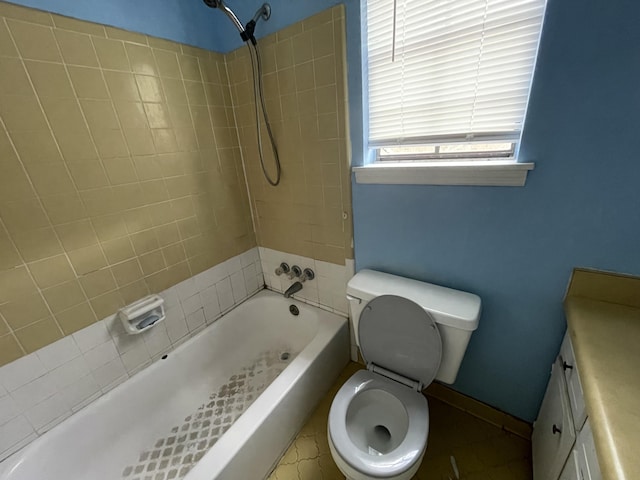 bathroom with vanity, bathtub / shower combination, and toilet