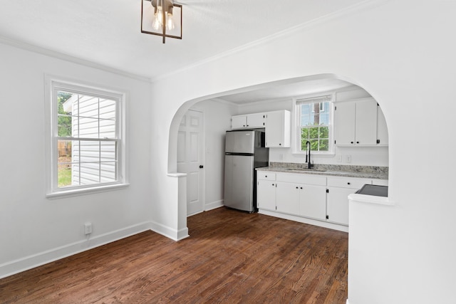 1611 Monte Sano Ave, Augusta, GA 30904 - kitchen featuring freestanding refrigerator, a sink, crown molding, dark wood-style flooring, and arched walkways