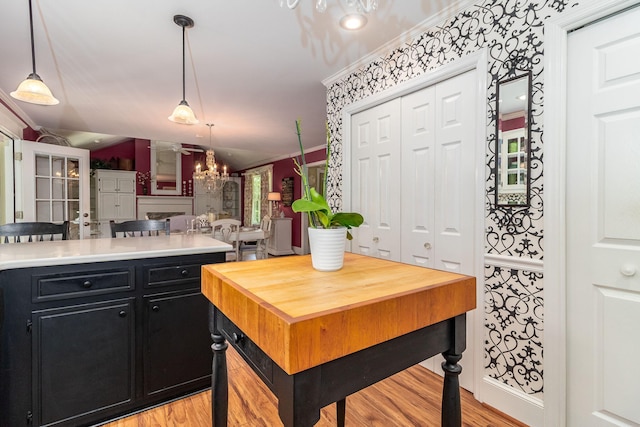 1300 Concord Ave, North Augusta, SC 29841 - kitchen with dark cabinets, light wood-style floors, lofted ceiling, hanging light fixtures, and butcher block counters