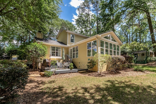1300 Concord Ave, North Augusta, SC 29841 - rear view of property with a chimney, a sunroom, a yard, and a deck
