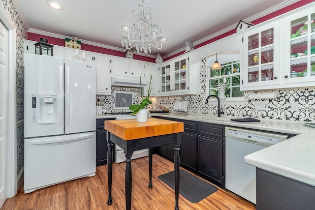 1300 Concord Ave, North Augusta, SC 29841 - kitchen featuring white appliances, a sink, under cabinet range hood, light countertops, and ornamental molding