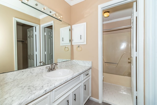 bathroom with shower / washtub combination, vanity, and ornamental molding